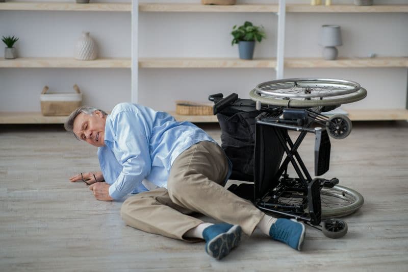 Elderly man falls from a wheelchair.