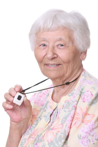 Elderly woman wearing a medical alert system pendant.