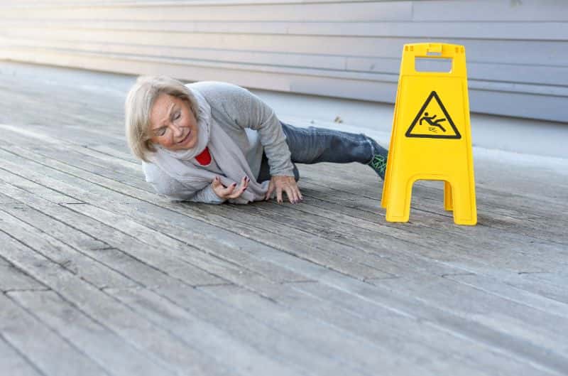 Elderly woman slips and falls on wet floor